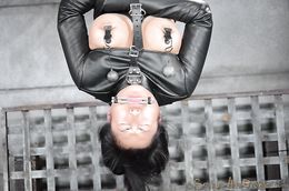 Asian slut in leather straitjacket forced to suck