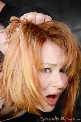 Redhead slave submissively sucks a massive boner